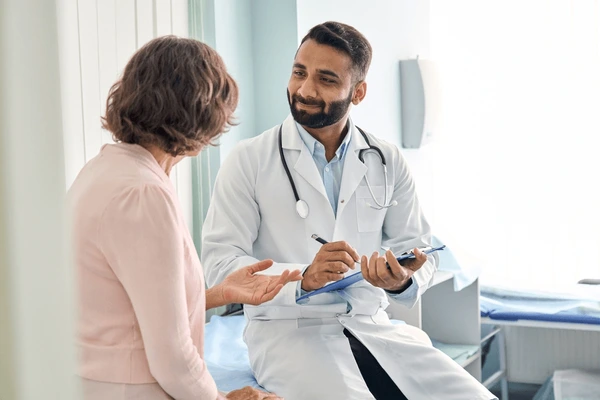 Home health specialist consulting a patient in Sargodha