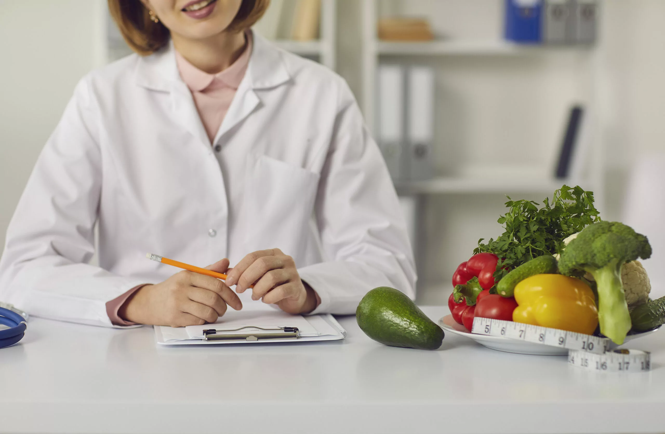 Nutritionist reviewing a personalised diet plan during a home consultation in Sargodha