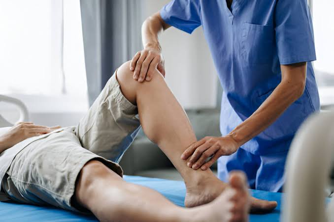 Physiotherapist performing a home physical therapy session in Sargodha